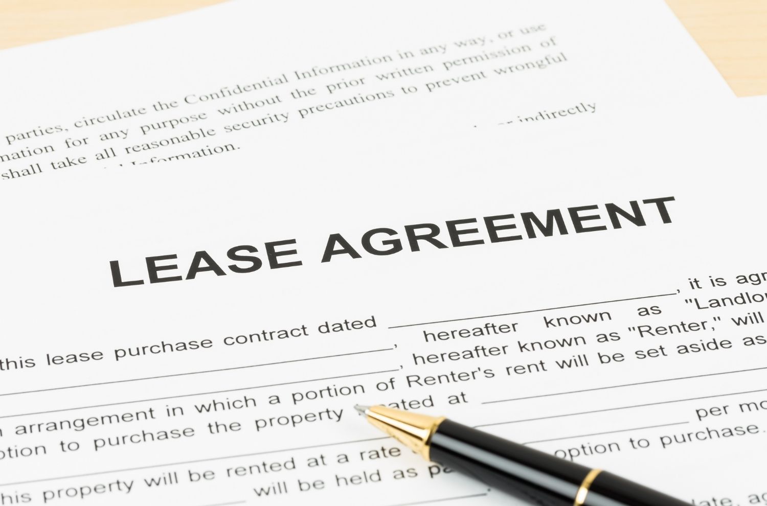 Pen sitting atop lease agreement documents
