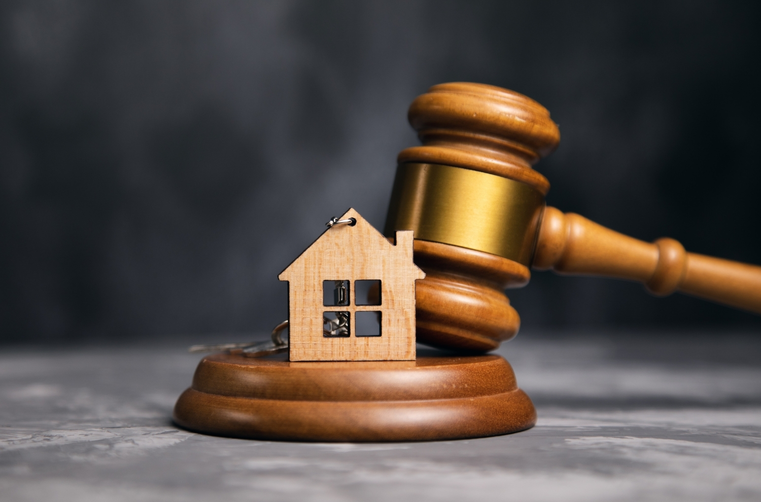 Court gavel and wooden model house