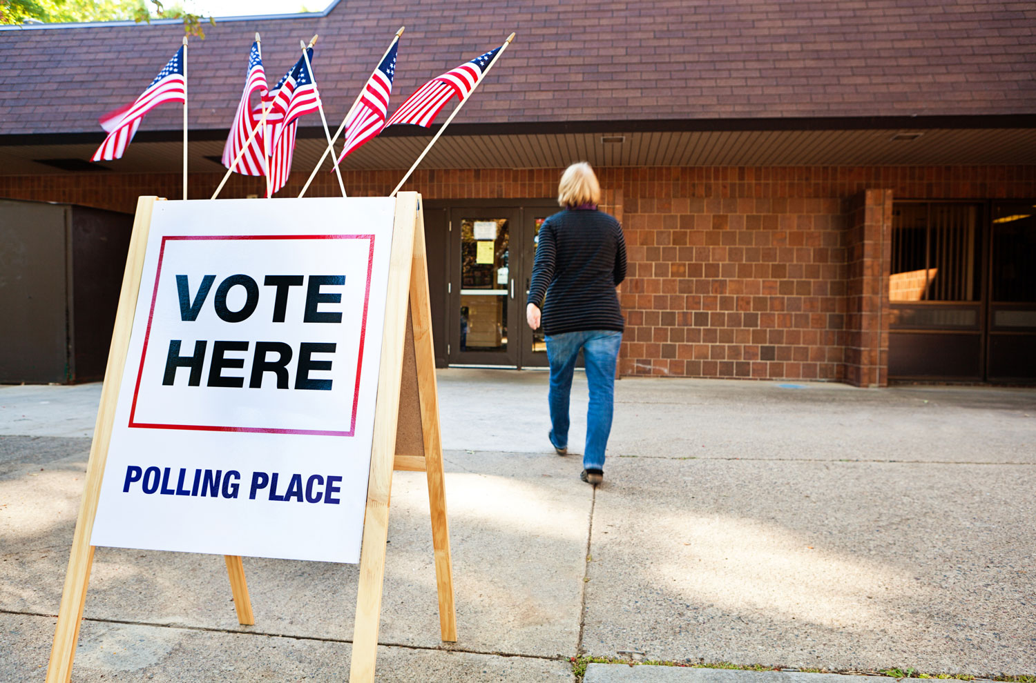 Vote here sign outside of school building used as a polling place