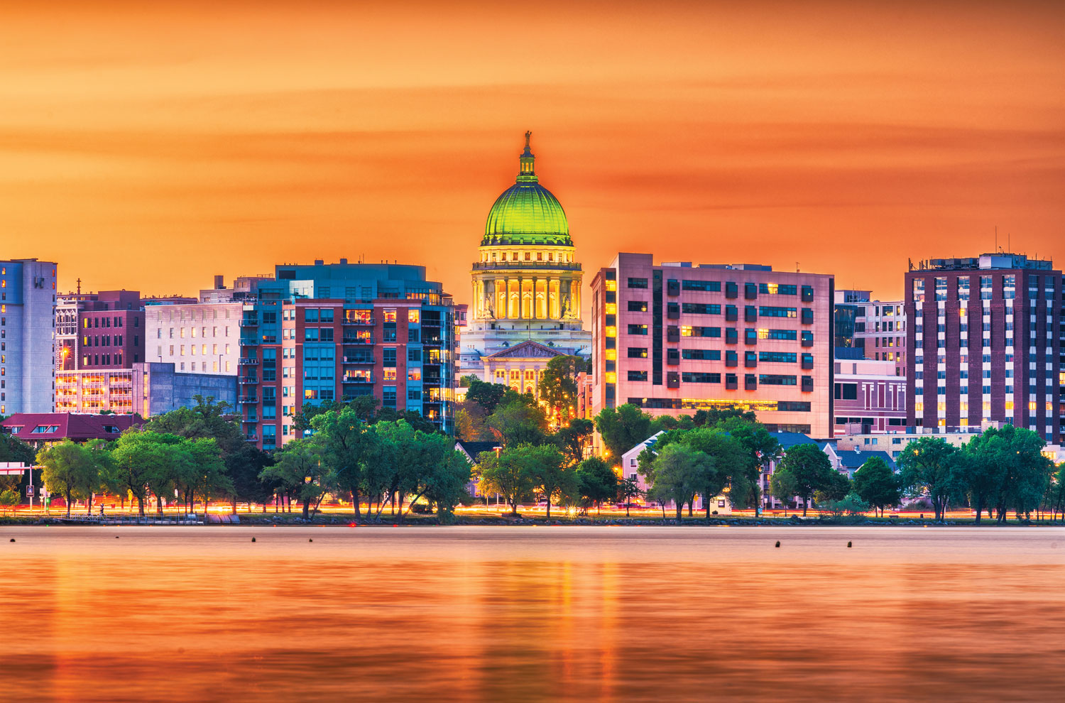 Wisconsin state capitol building and Madison skyline in golden hour evening sunlight