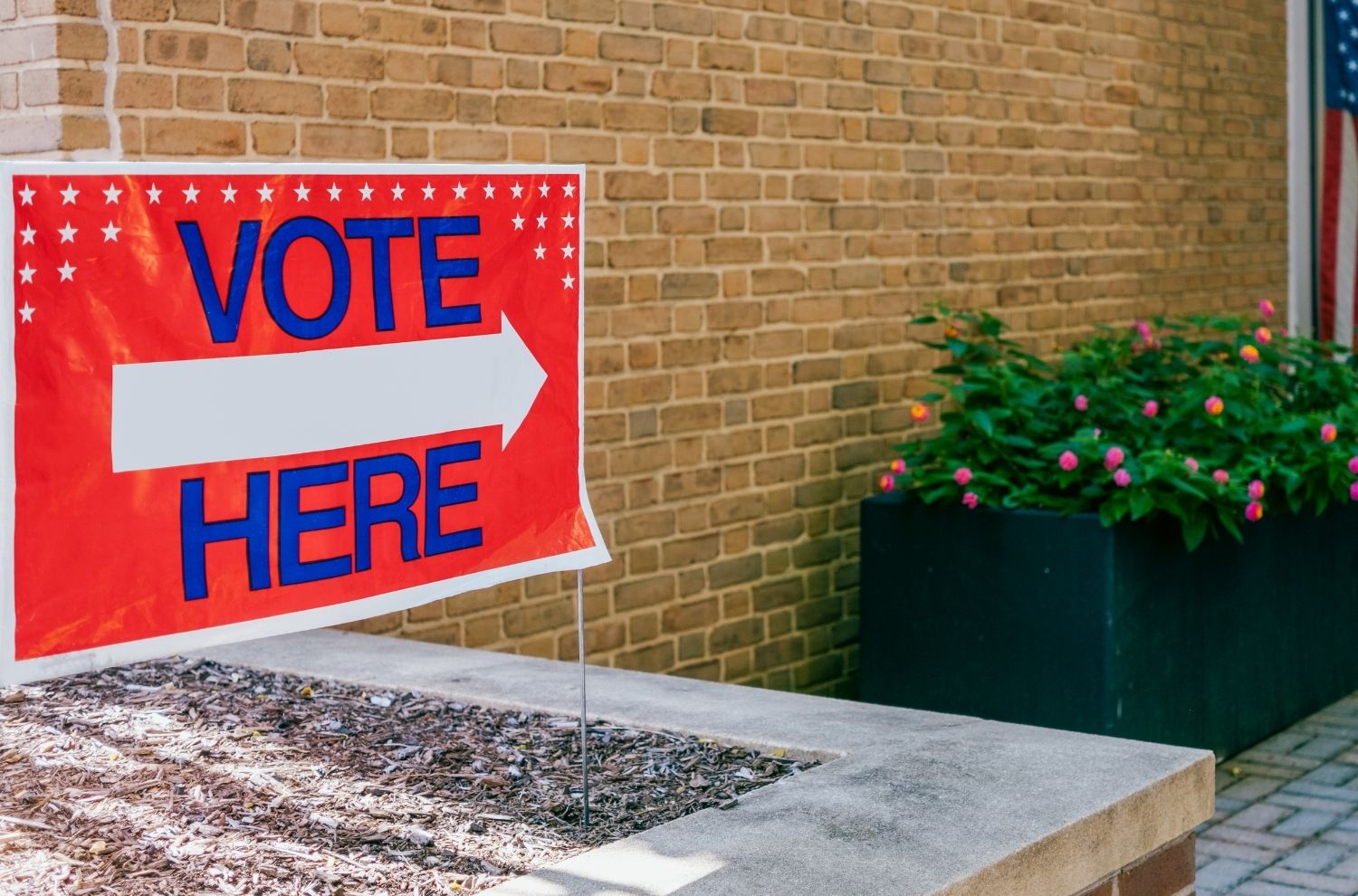 "Vote here" sign outside of library double doors