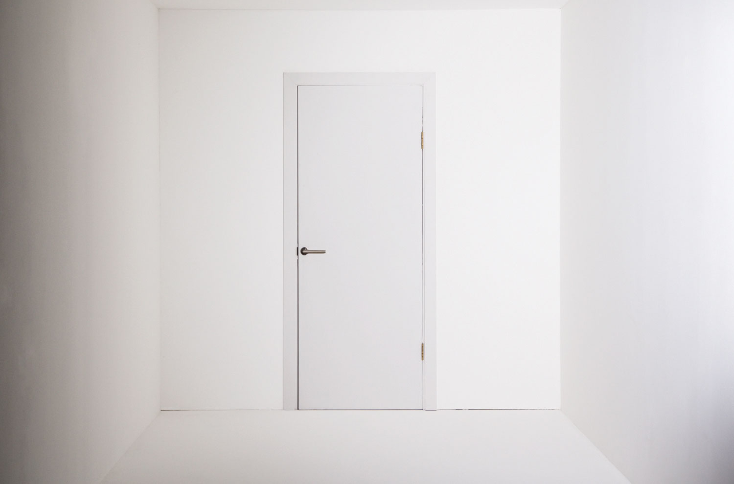 Closed door against blank wall